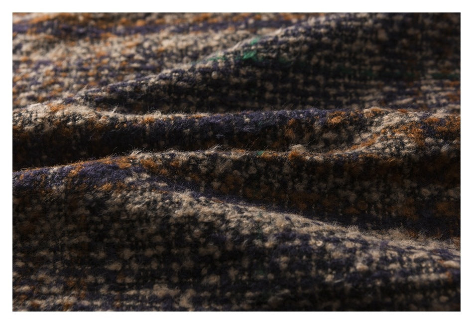 Macro view of the raised, fuzzy texture and mottled pattern of the garment fabric.