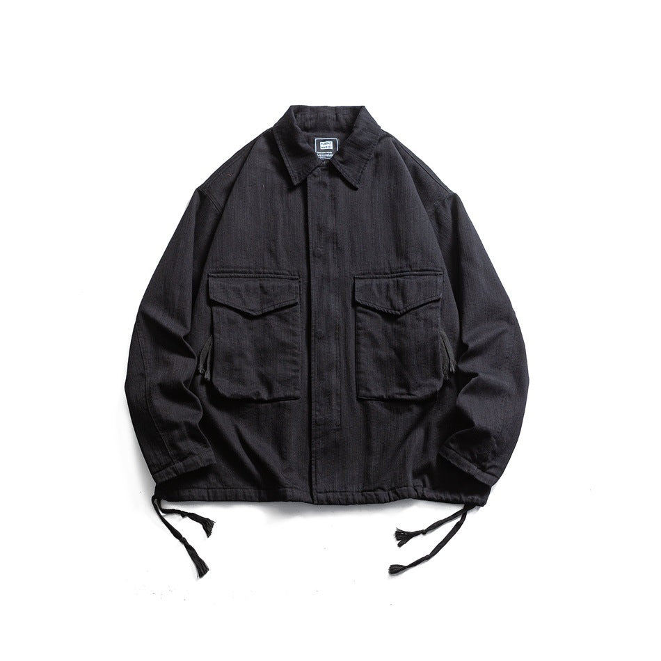 Black collared jacket flat lay with two large flap chest pockets and tasseled hem drawcords
