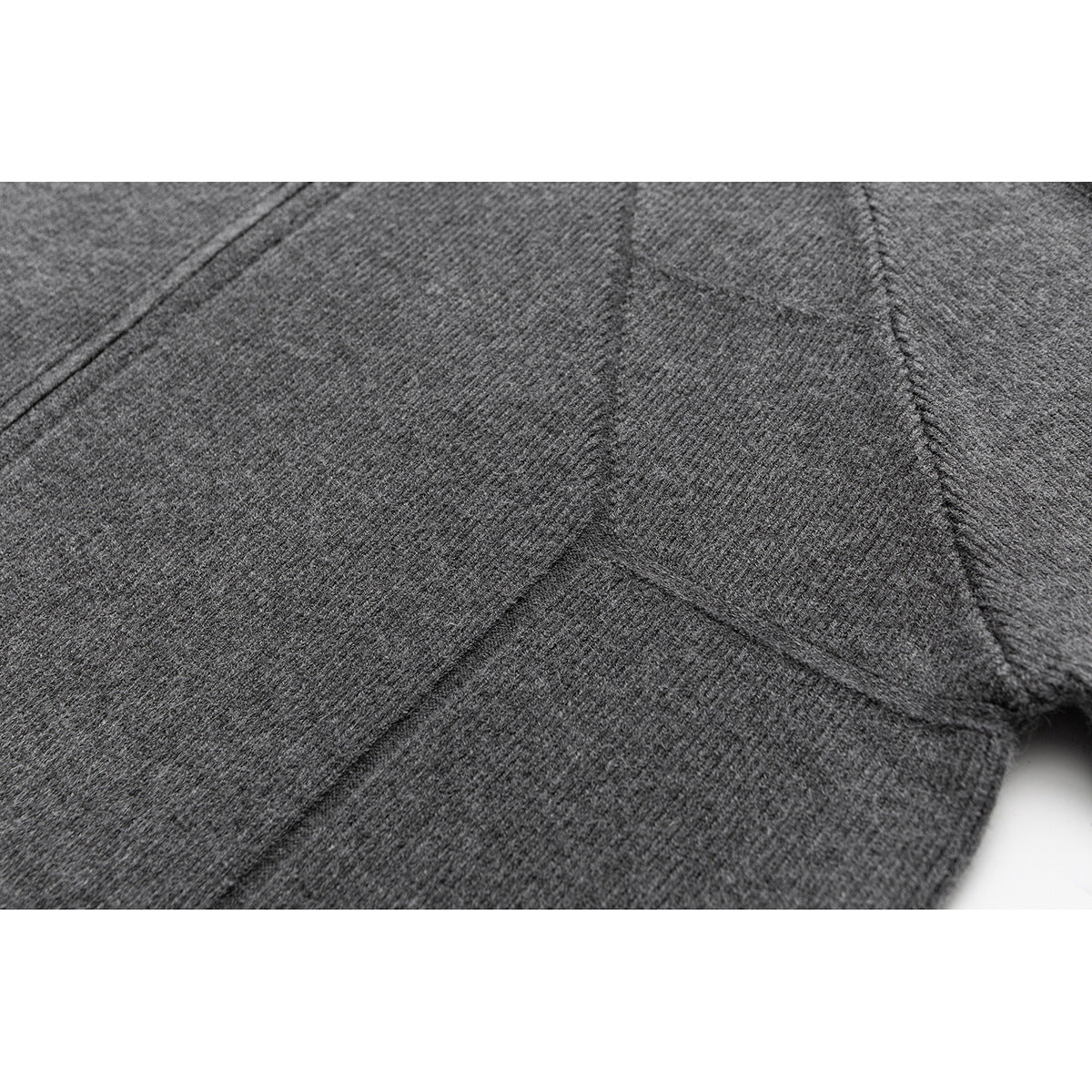 Close-up of gray knit fabric with visible seam construction and fine texture.