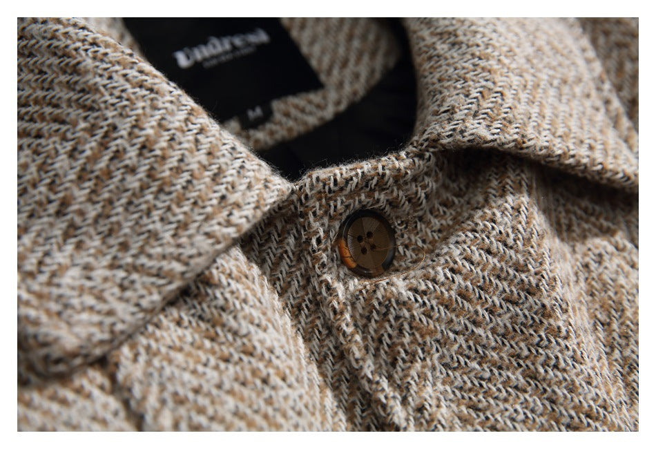 Close-up of the coat's lapels and front button, with a black neck label visible inside.