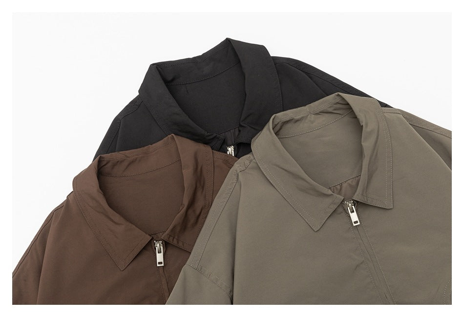 Three collared zip-front jackets arranged together in black, brown, and taupe, shown close up.