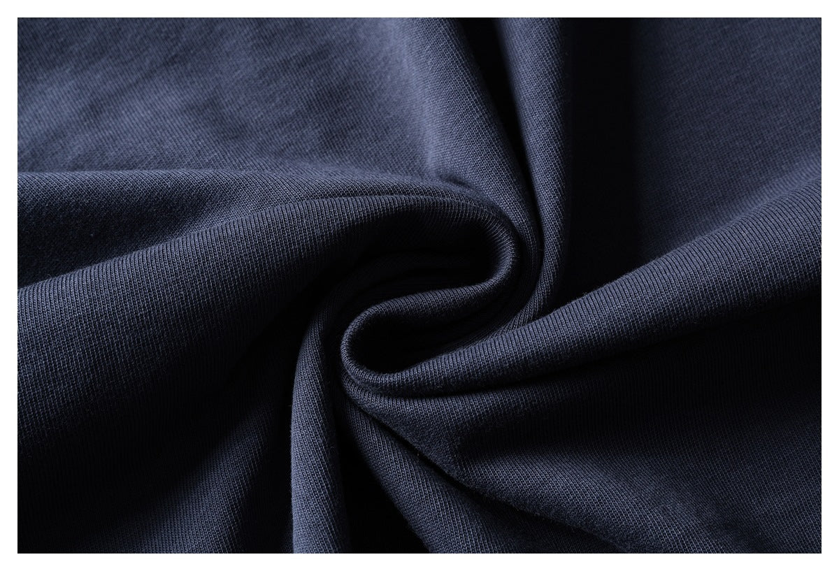Dark navy garment fabric gathered to show its texture and drape.