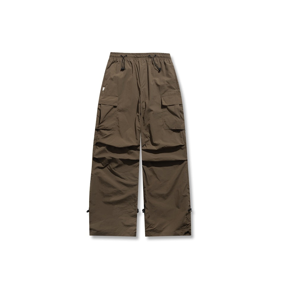 Brown wide-leg cargo pants with elastic drawcord waist, flap pockets and toggle hems, flat front view