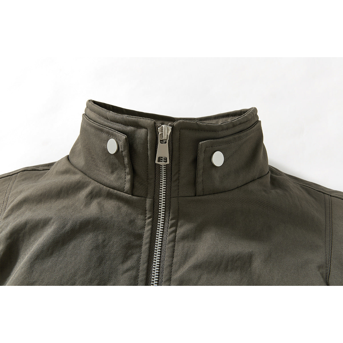 Close-up of an olive-gray jacket's stand collar, silver center zipper, and snap-tab collar fasteners.