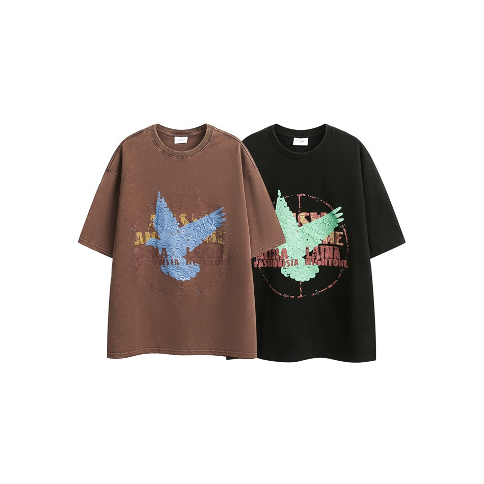 Two oversized graphic T-shirts displayed side by side: brown with a blue eagle and black with a mint-green eagle.