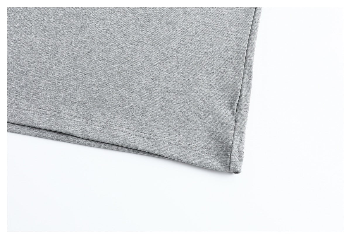 Close-up of the straight stitched hem on a heather gray garment.