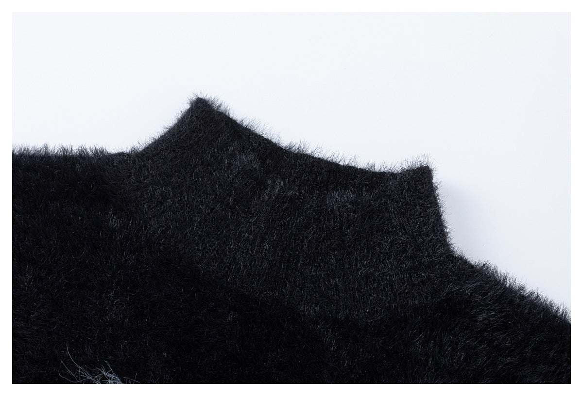 Close-up of the raised neckline edge on a black fuzzy garment.