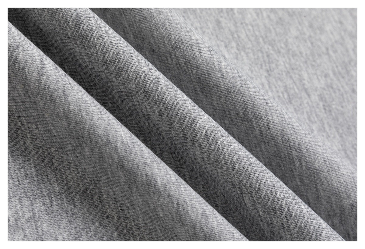 Close-up of gray knit fabric arranged in soft diagonal folds.
