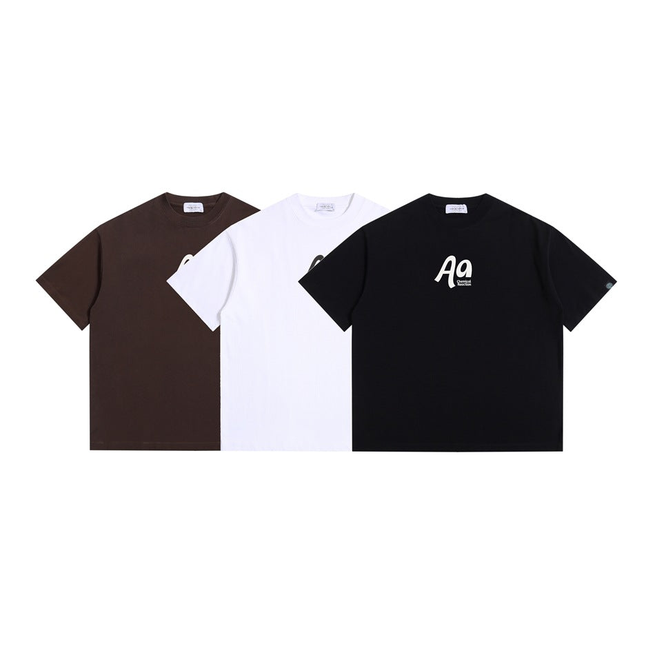 Three short-sleeve crew-neck T-shirts shown from the front in brown, white, and black, with a small chest print.