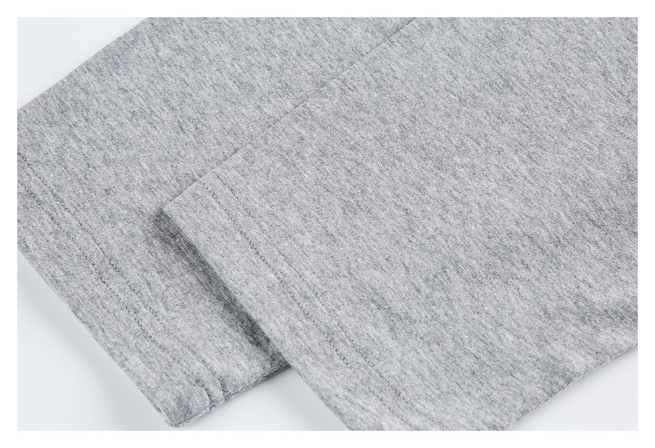 Close-up of gray heather sweatshirt fabric with a stitched edge and folded section.