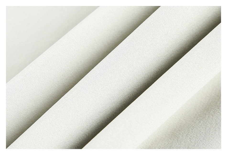 Close-up of softly folded white fabric showing its surface texture.