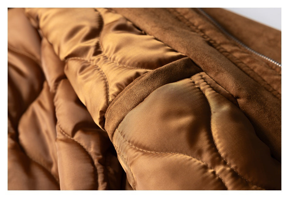 Close-up of the brown jacket's quilted satin-like lining beside the front zipper.