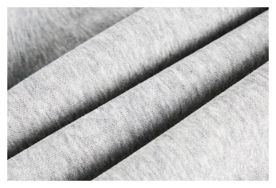 Close-up of the heather-gray garment fabric arranged in soft folds.