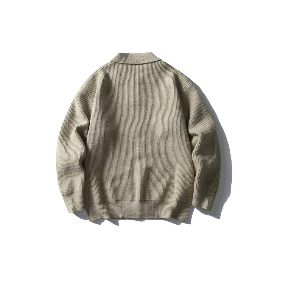 Back view of a taupe-beige ribbed knit sweater with a folded collar and long sleeves, shown flat on white.