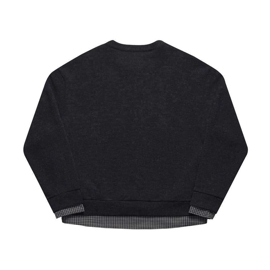 Back view of a charcoal cardigan with checked fabric showing below the hem and at the cuffs.