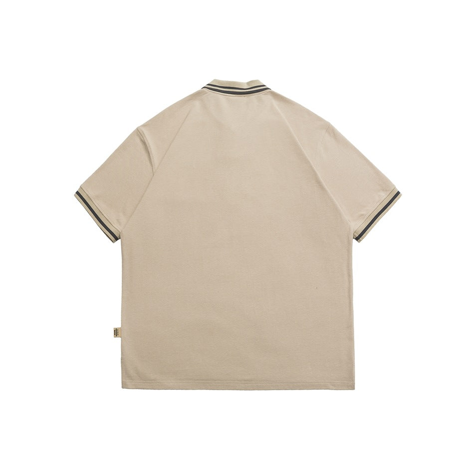 Back view of a khaki short-sleeve polo shirt with dark gray striped collar and cuffs and a small label at the side seam
