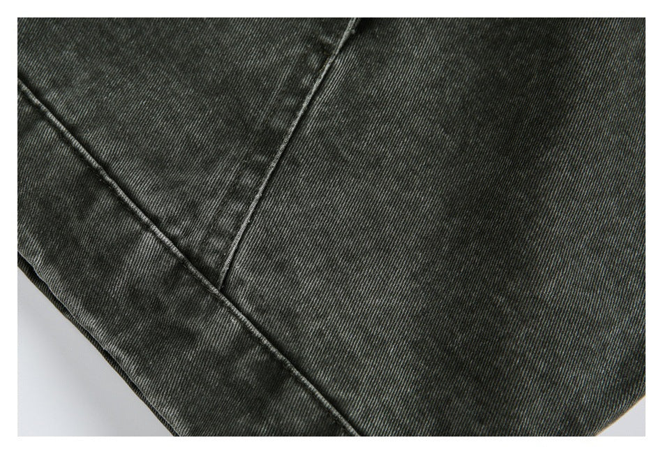 Close-up of the jacket's dark fabric, panel stitching, and lower edge.