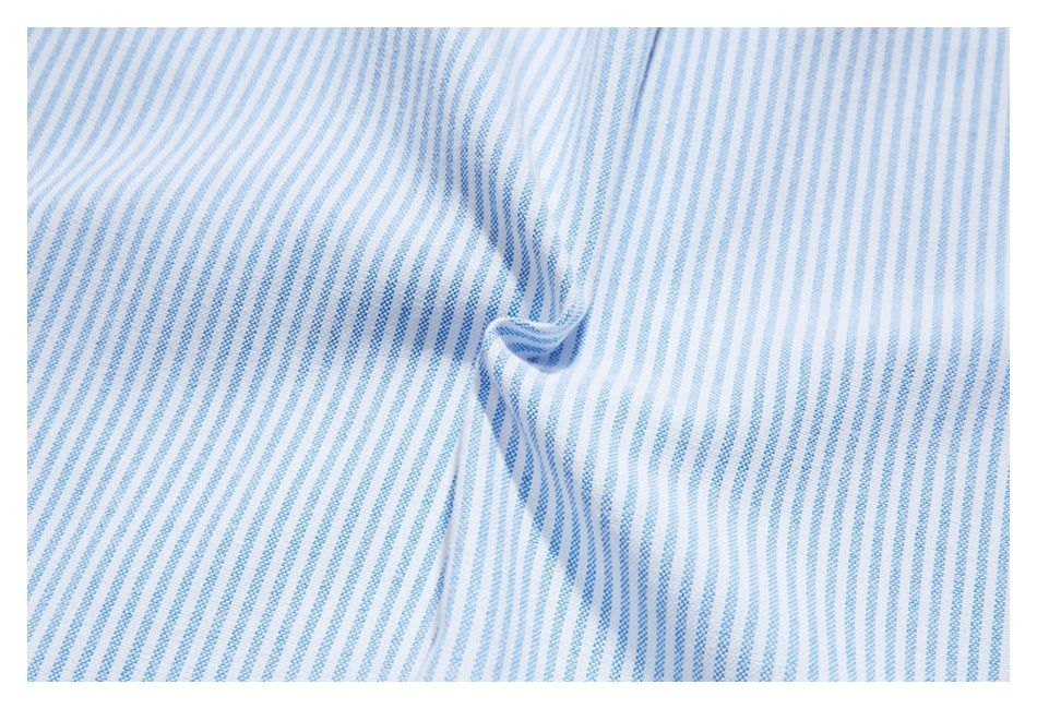 Close-up of blue-and-white striped shirt fabric with a small folded seam detail.