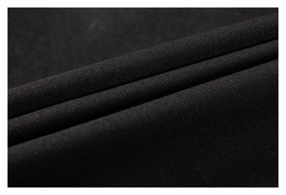 Macro view of black fabric folded to show its textured surface.