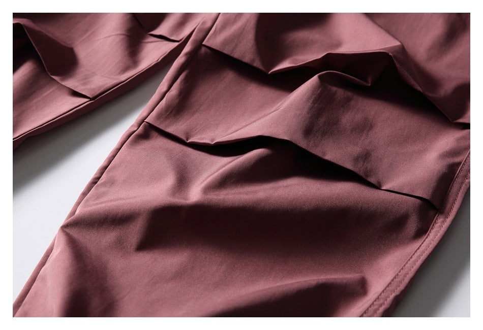 Close-up of a flap cargo pocket on dusty mauve trousers.