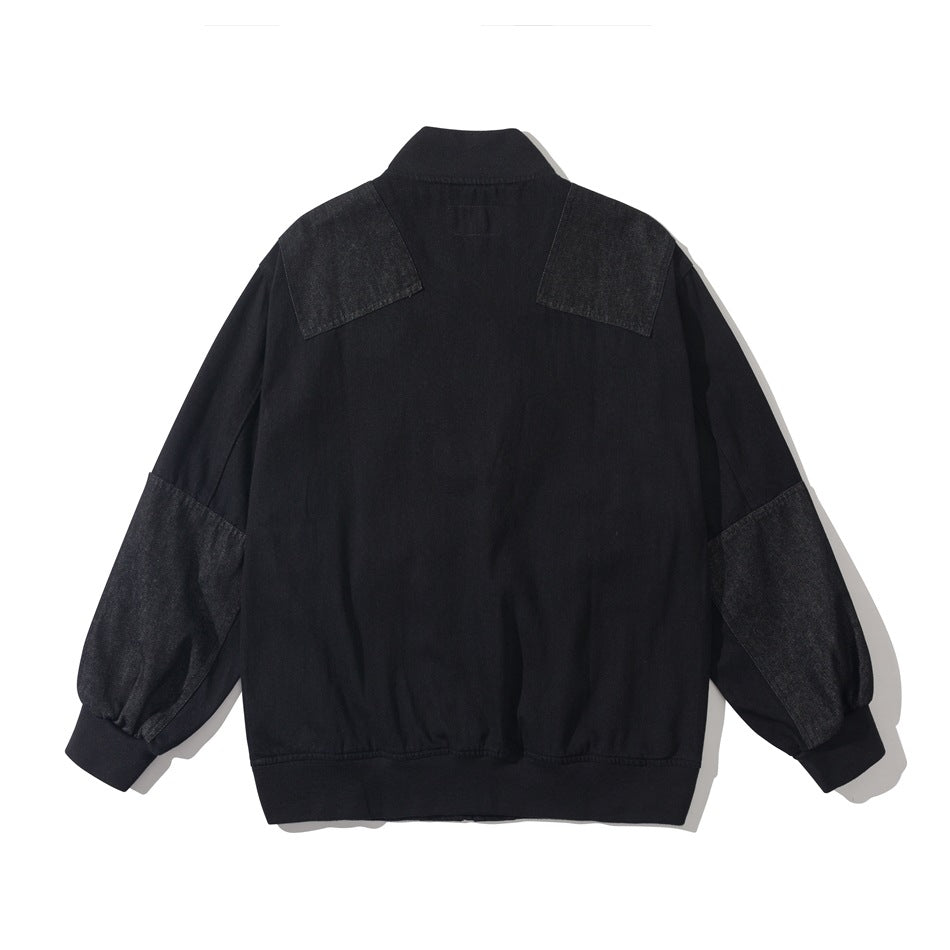 Back view of a black jacket with contrasting shoulder and sleeve panels and ribbed collar, cuffs, and hem.