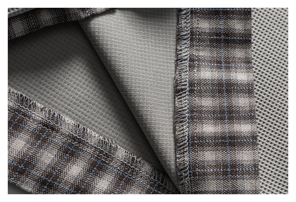 Close-up of the shorts' interior seam and hem, showing gray fabric and brown plaid trim.