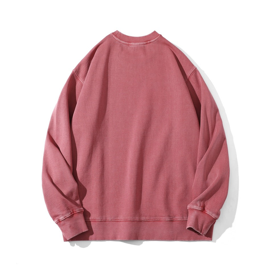 Dusty rose crewneck sweatshirt shown flat, with long sleeves and ribbed cuffs and hem.