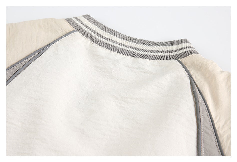 Close-up of the jacket's back collar, striped ribbed trim, and gray piping.