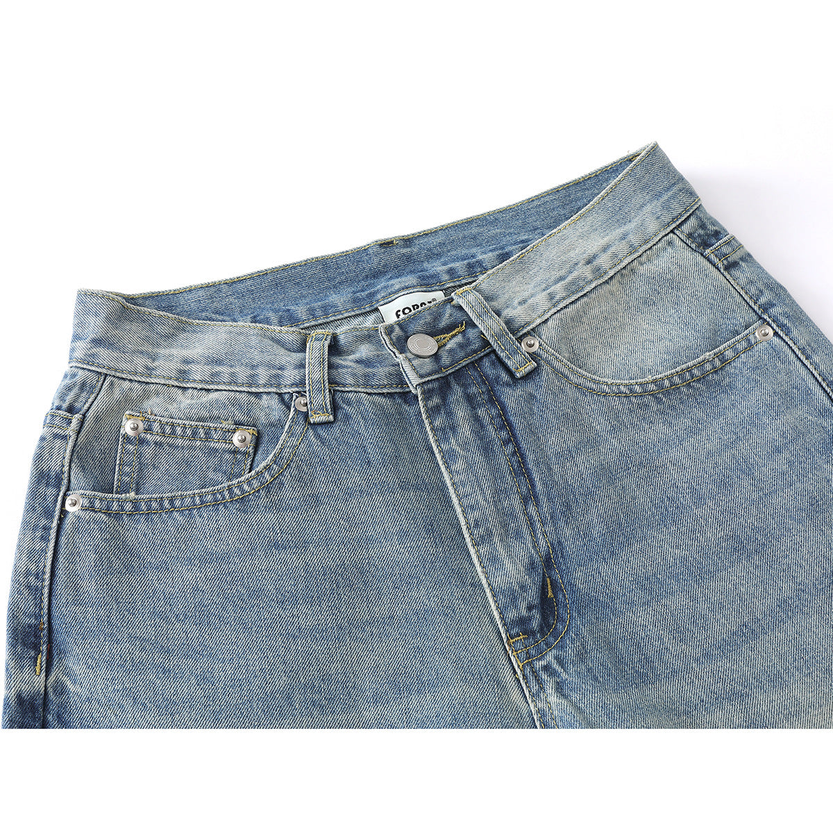 Close-up of the front waistband and pockets of light-wash blue jeans with contrast stitching and metal rivets.