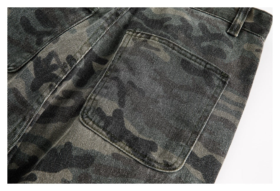Close-up of a rear patch pocket and belt loop on dark camouflage trousers.