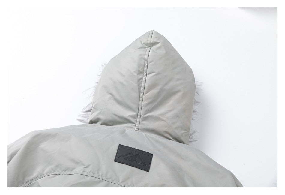 Back view of a light gray jacket with a hood and a small dark patch on the upper back.