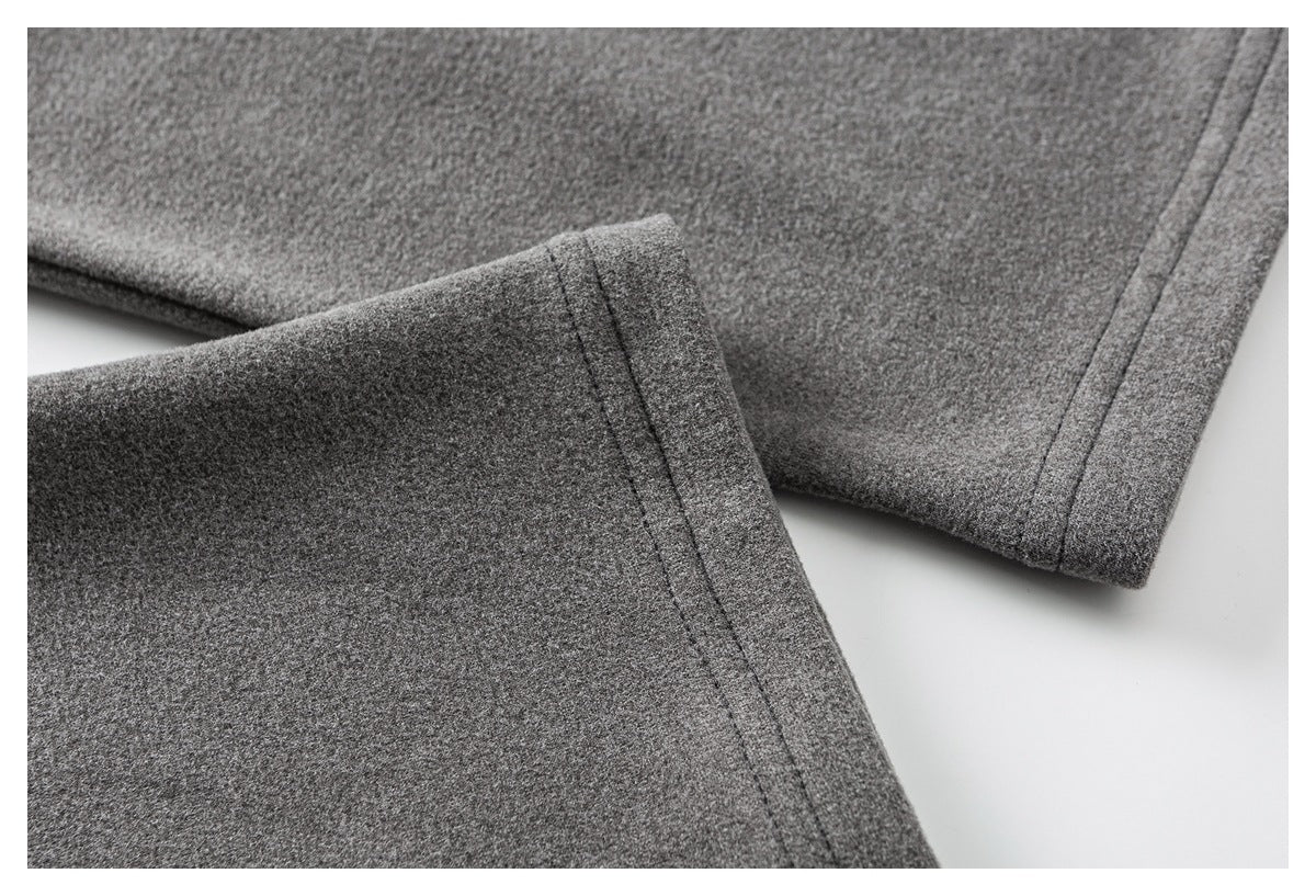 Close-up of gray garment edges with narrow stitched hems.