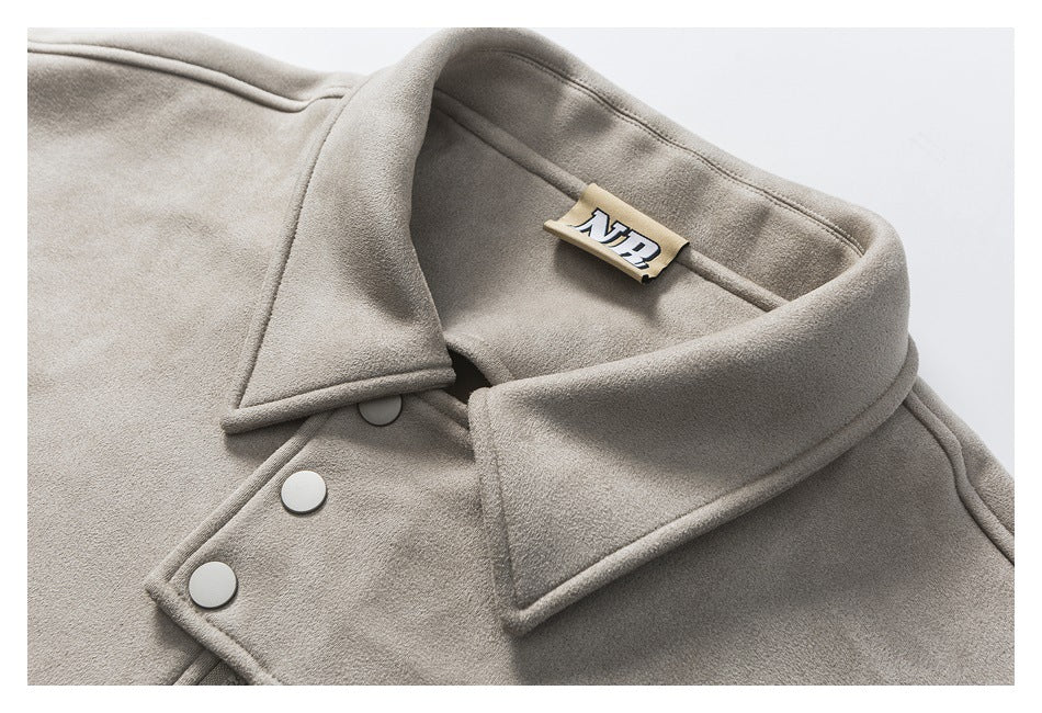 Close-up of the taupe jacket's wide collar, inner label, and round front snaps.