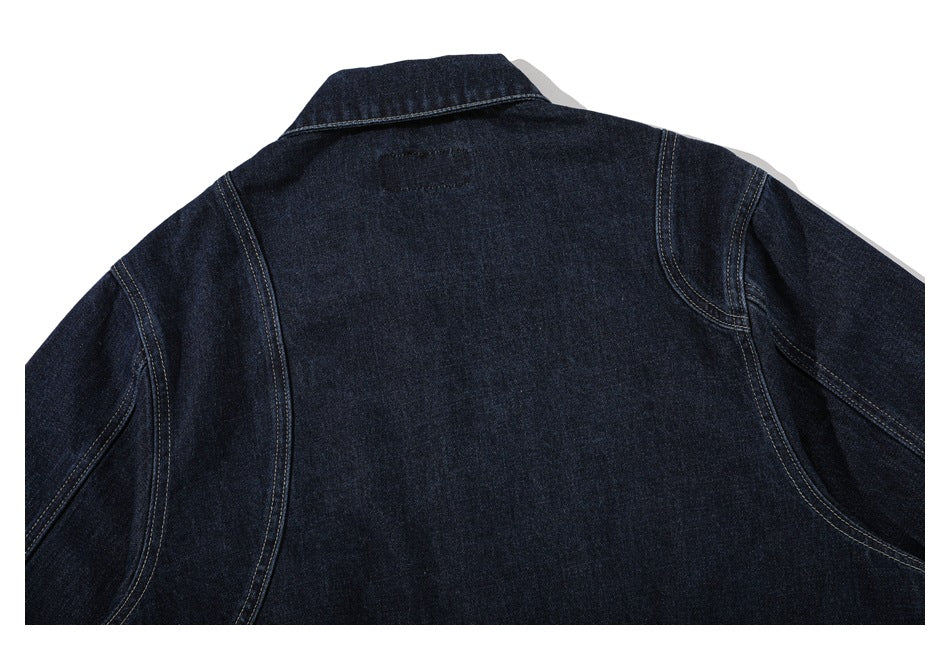 Cropped back view of a dark indigo denim jacket, showing the collar, shoulder seams, and sleeves.