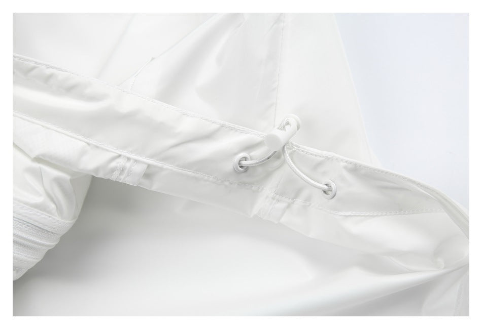 Close-up of a white jacket's drawcord adjuster threaded through reinforced eyelets.
