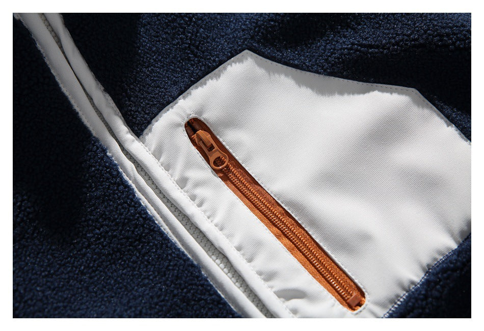 Close-up of a brown zipper pocket set into the white lining of a navy fleece jacket.