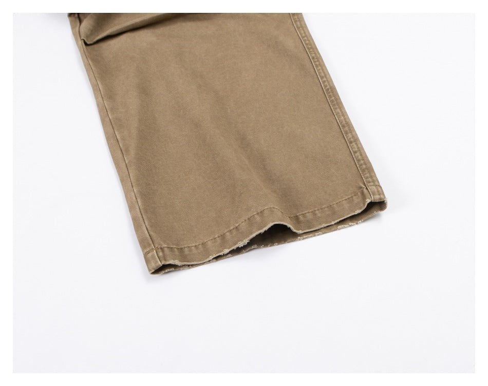 Close-up of the tan trouser leg and stitched hem.