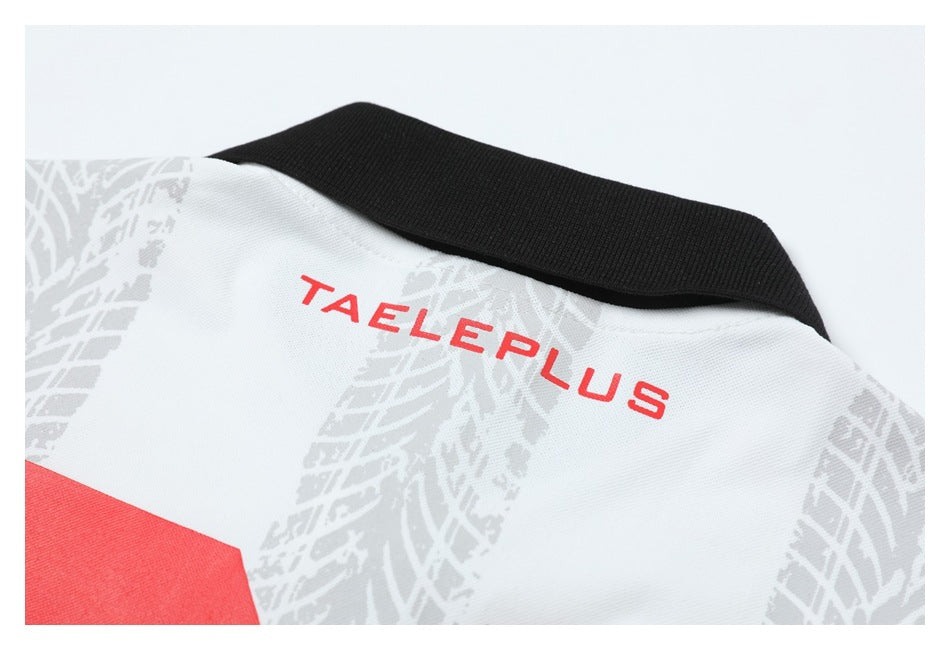 Close-up of the back neckline of a white polo shirt, showing its black collar, red lettering, and gray pattern.