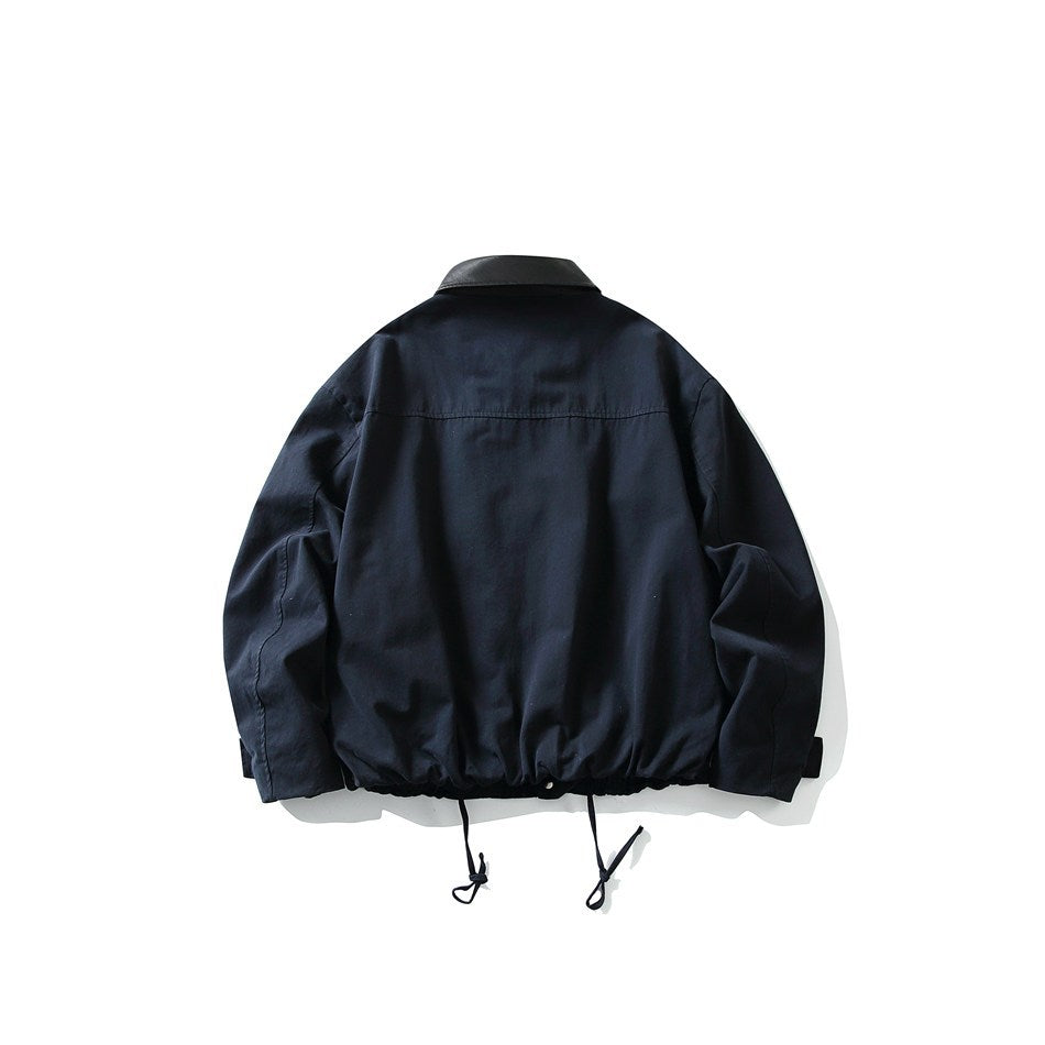 Back view of a navy jacket with a black collar, a horizontal shoulder seam, and drawstrings at the hem.