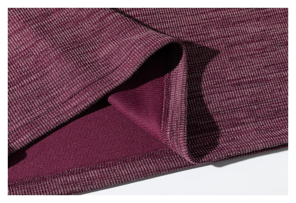 Close-up of the burgundy shirt's inside hem and stitched edge.
