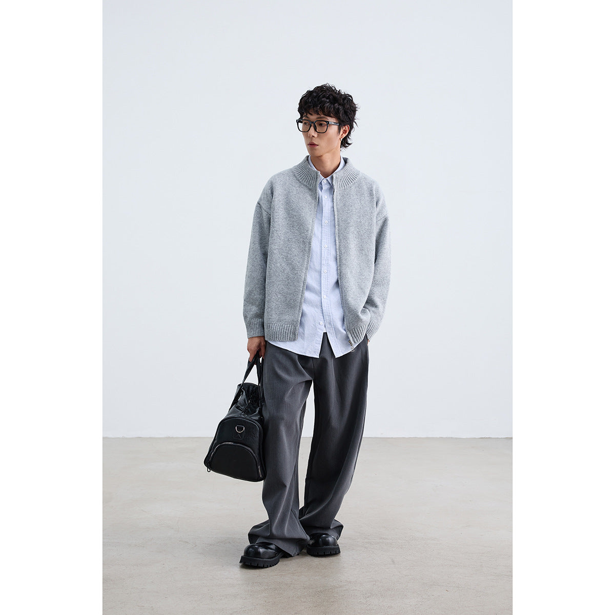 Model wearing a light gray zip-front cardigan with a ribbed stand collar, cuffs, and hem.