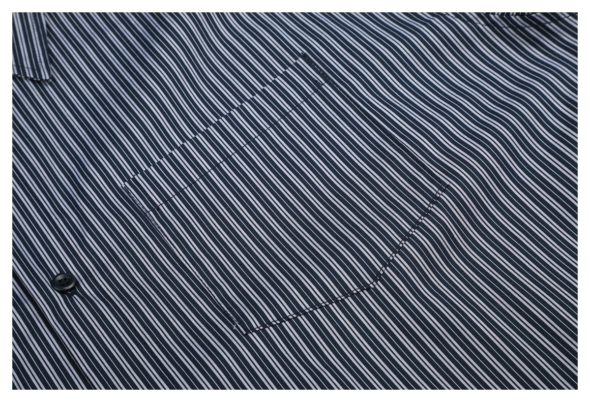 Close-up of the chest pocket on a dark navy shirt with narrow white stripes.