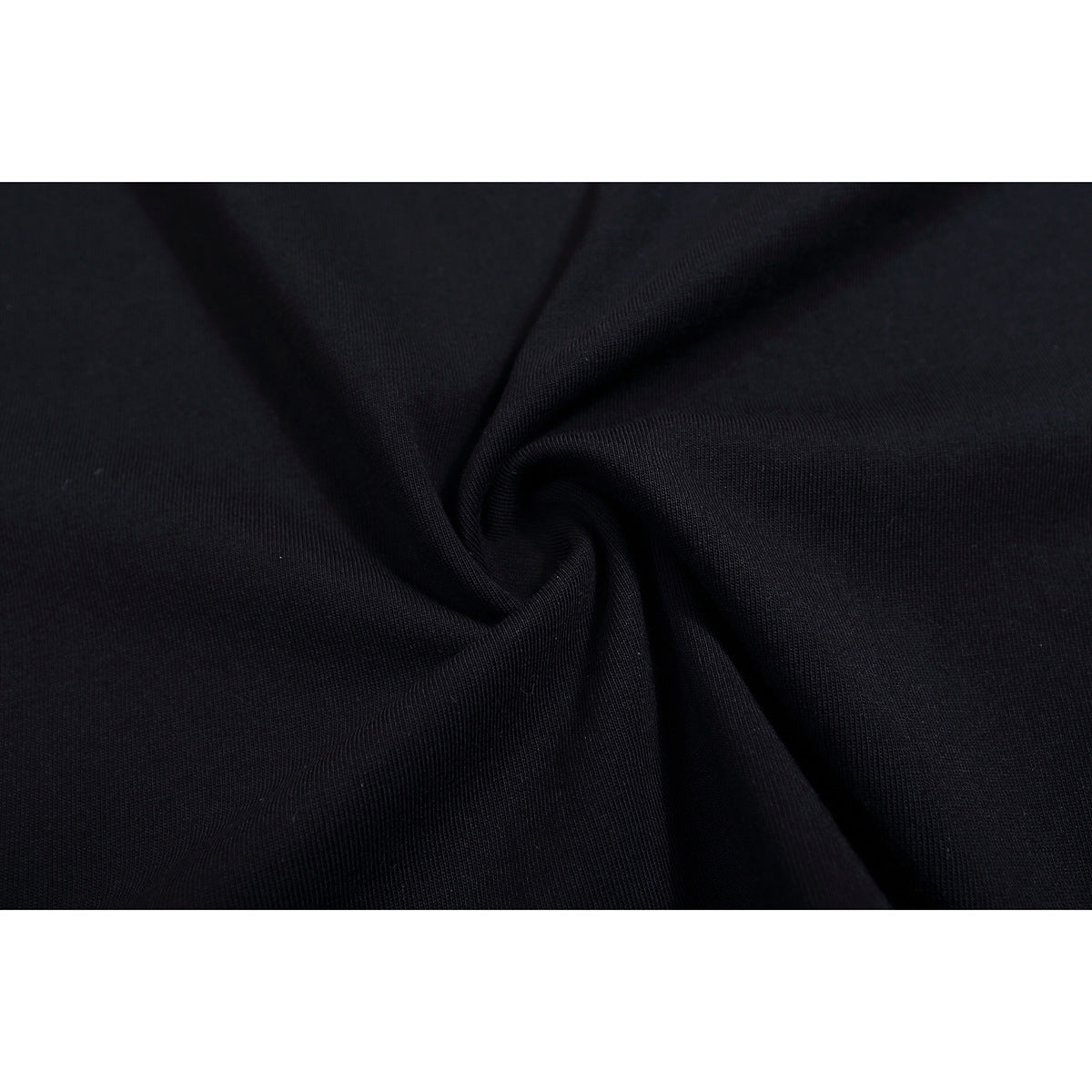 Close-up of black fabric gathered into a fold, showing its surface texture.