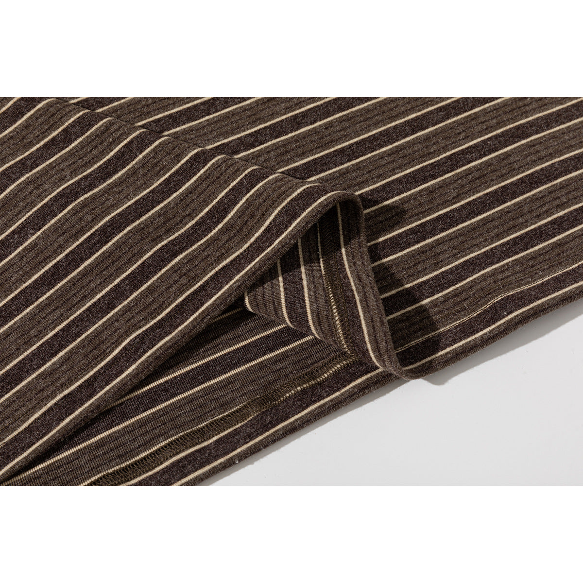 Close-up of the brown striped T-shirt's folded hem and stitching.
