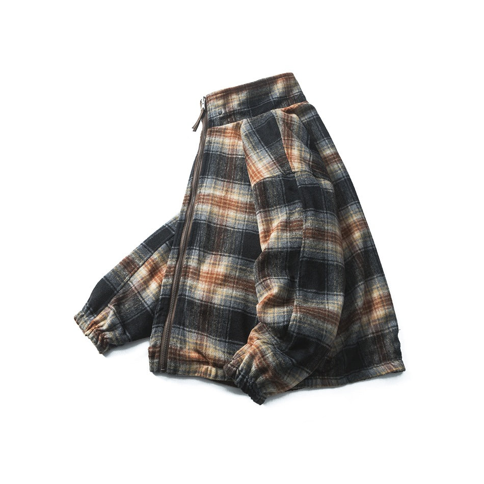 Angled flat lay of a dark plaid zip-up jacket with a stand collar and elastic cuffs on a white background.