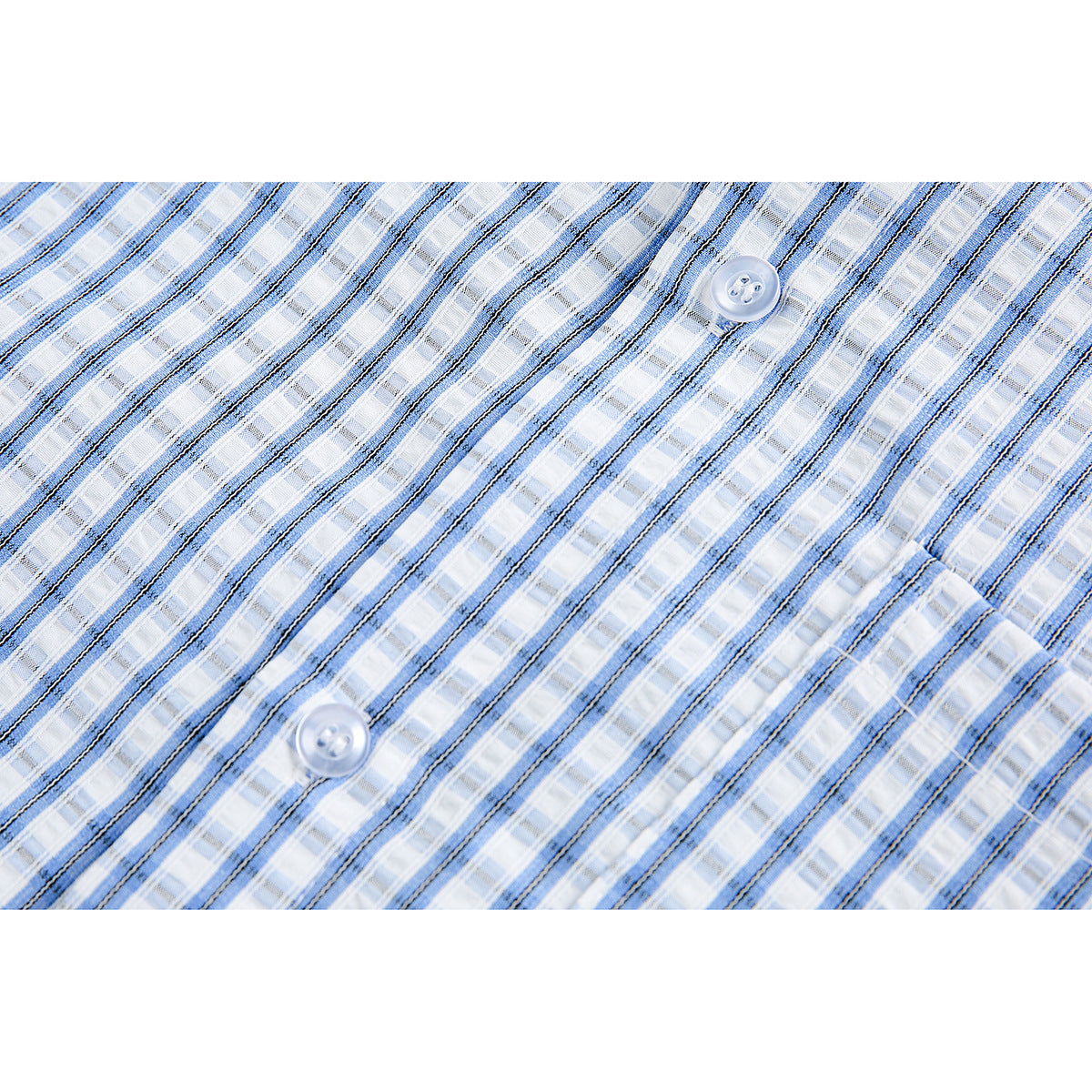 Close-up of blue-and-white plaid shirt fabric with thin dark stripes and two white buttons.