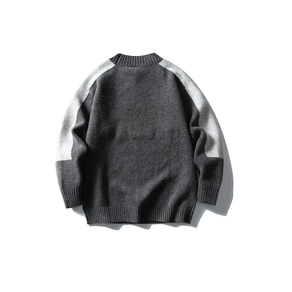 Dark gray knit sweater back view with light gray shoulder and sleeve panels and ribbed hem, flat lay