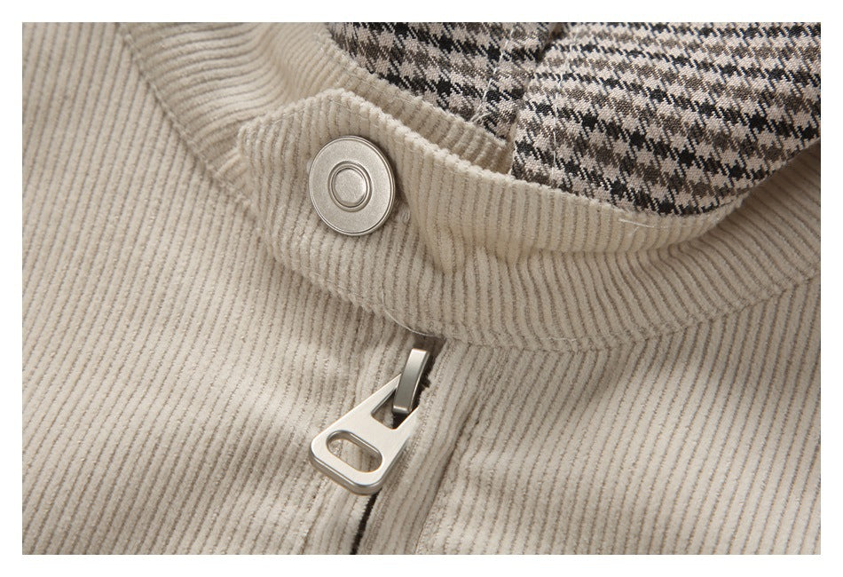 Close-up of the cream corduroy jacket's zipper, snap closure, and check-patterned lining.