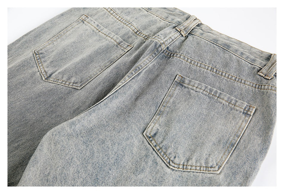 Flat-lay rear view of light-wash denim shorts with two patch pockets and belt loops.