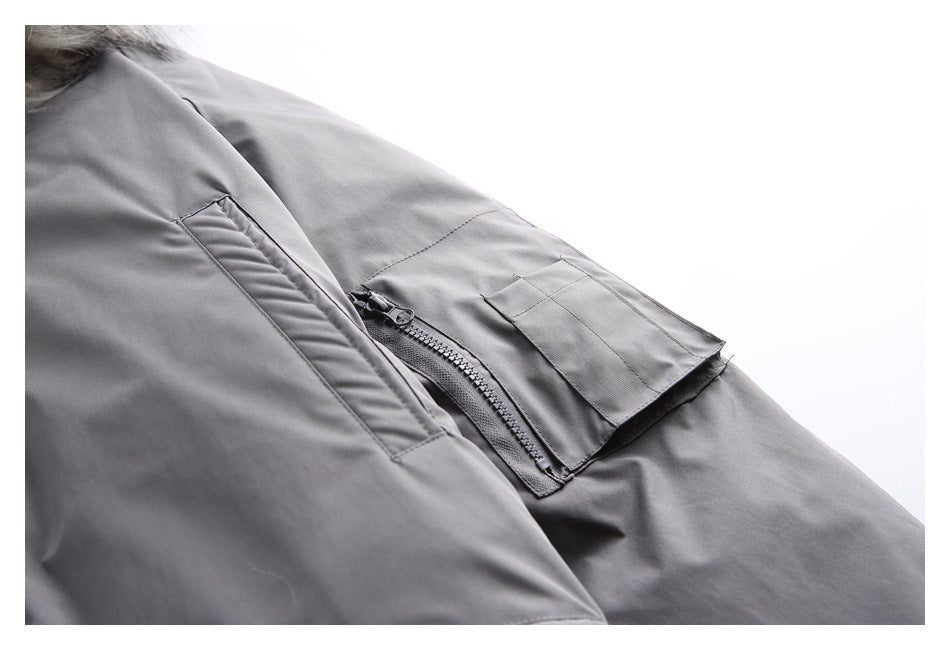 Close-up of the charcoal-gray sleeve with a zip pocket and layered flap detail.